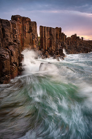 Waves crashing against rocks at the Bombo Quarry in New South Wales Australia by photographer Mieke Boynton