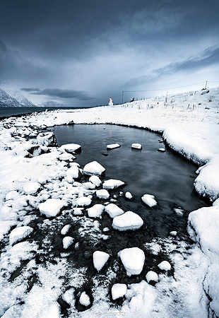 Snow and ice and a little lighthouse in Norway by photographer Mieke Boynton